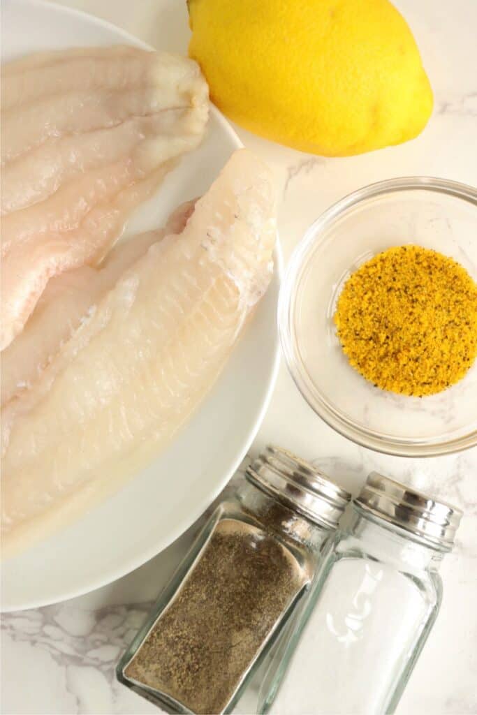 Overhead shot of individual ingredients for pan fried catfish in bowls. 