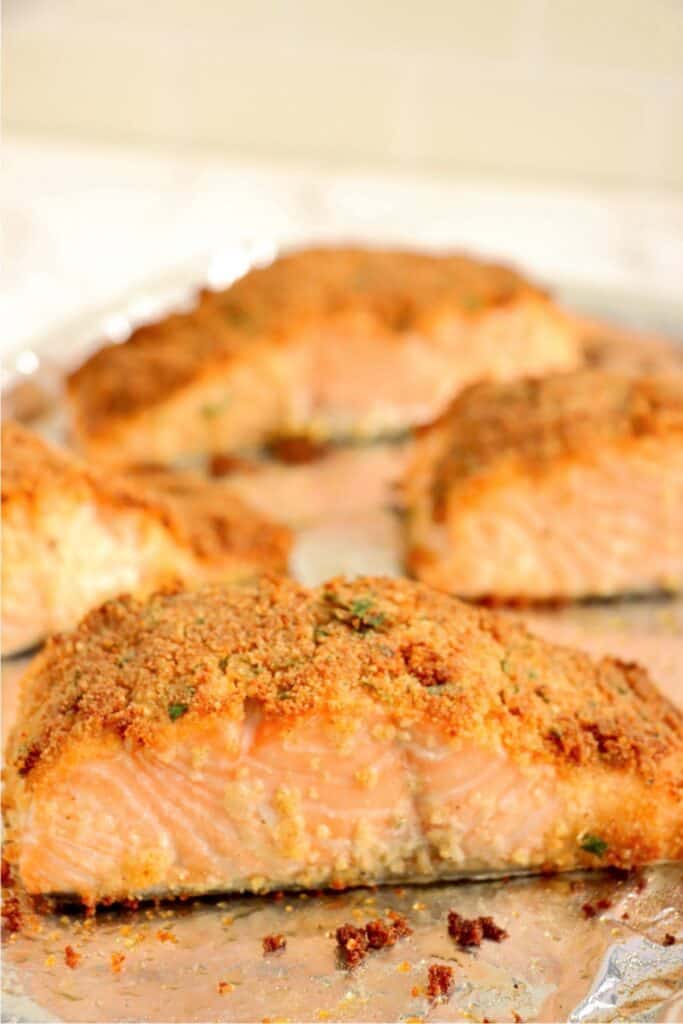 Closeup shot of baked herb crusted salmon fillet. 