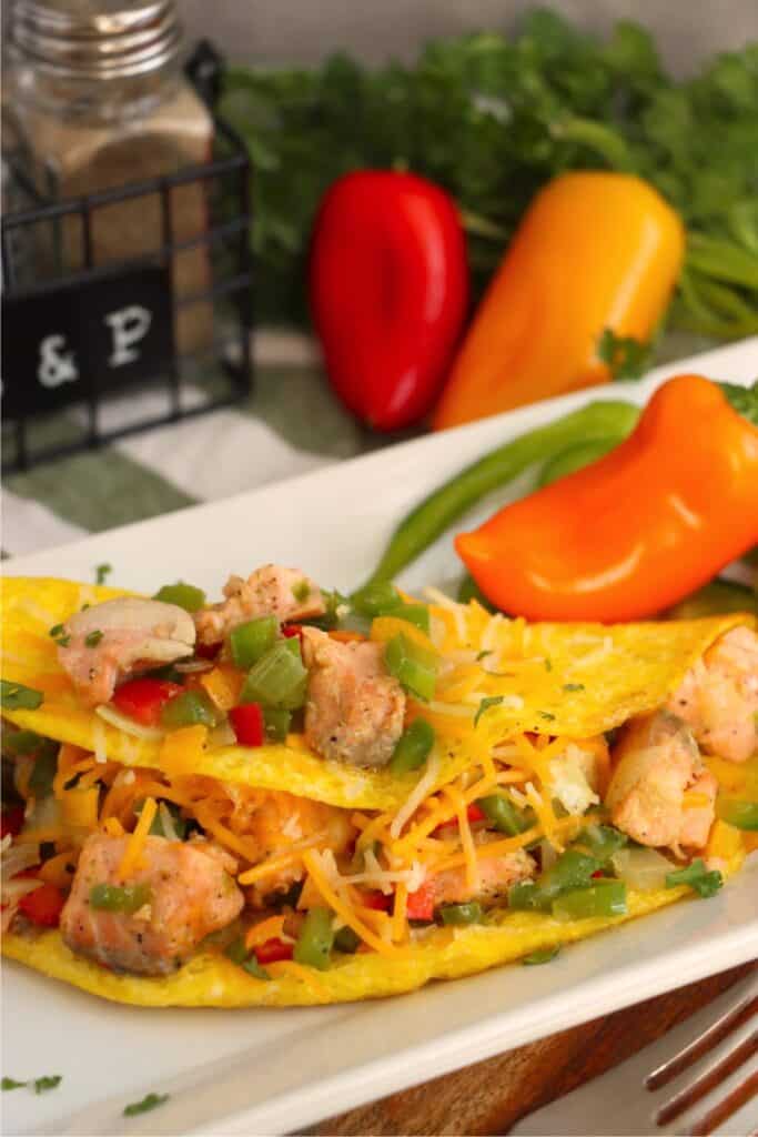 Closeup shot of salmon omelet with mini bell pepper on plate. 