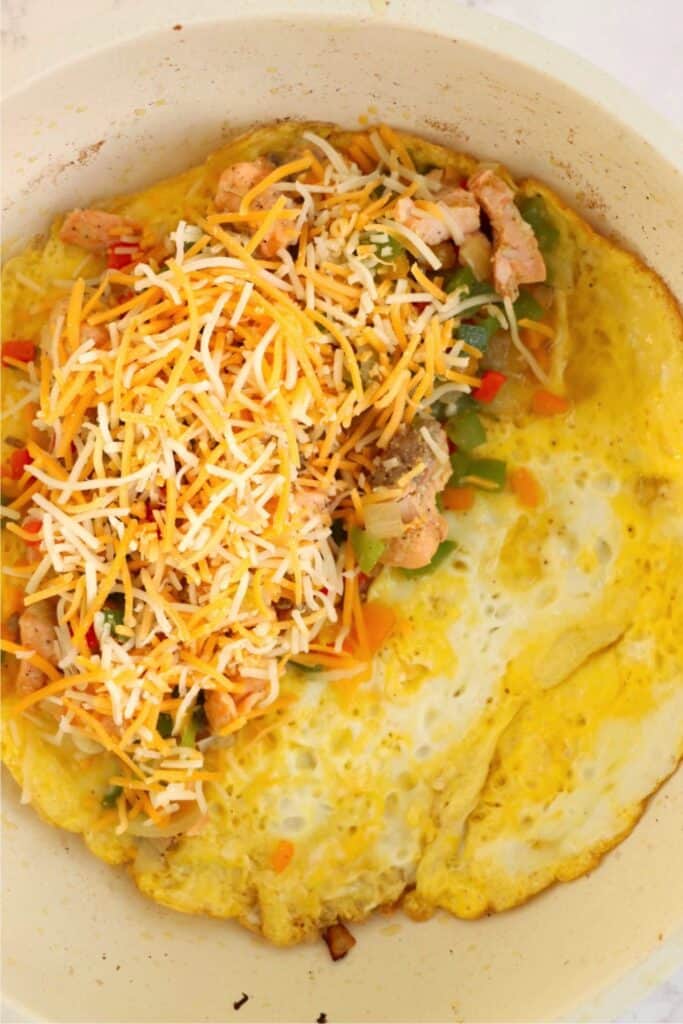 Overhead shot of open-face omelet in pan.