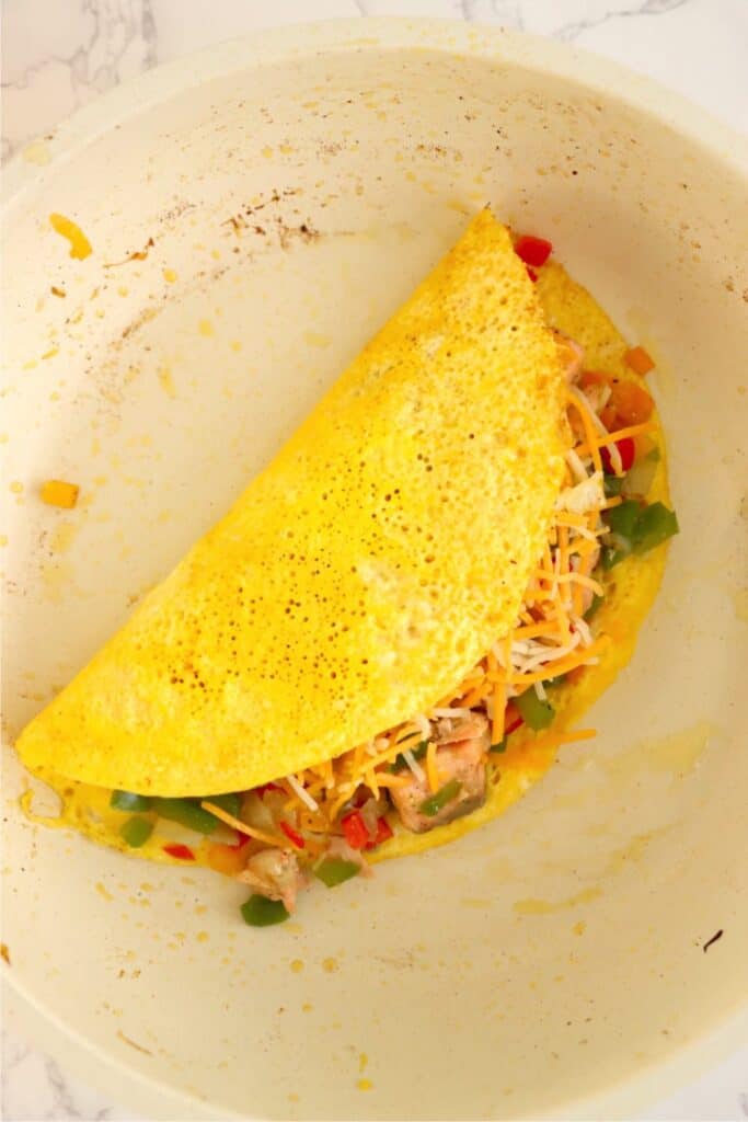 Overhead shot of salmon omelet in pan. 