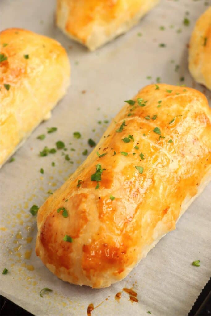 Golden brown salmon Wellington on baking sheet. 