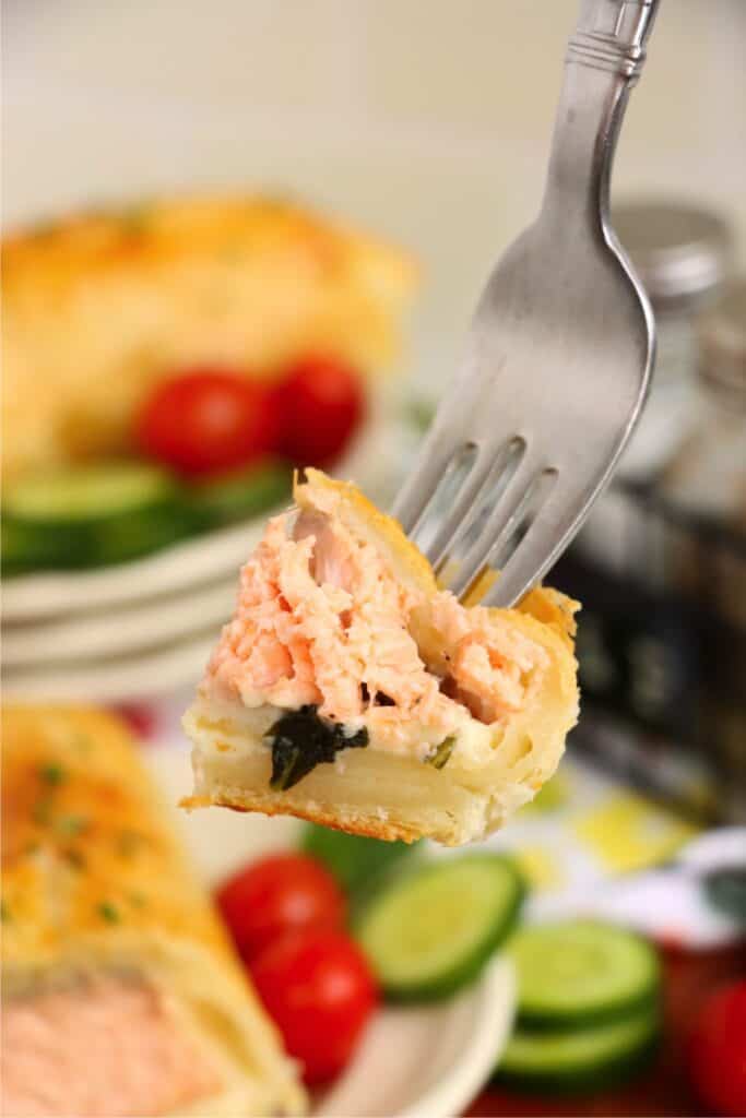Closeup shot of forkful of salmon Wellington. 