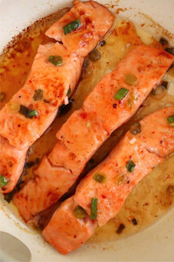 Overhead shot of cooked sweet chili salmon in skillet.