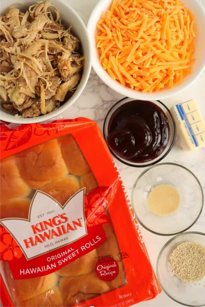 Overhead shot of individual BBQ chicken slider ingredients in bowls