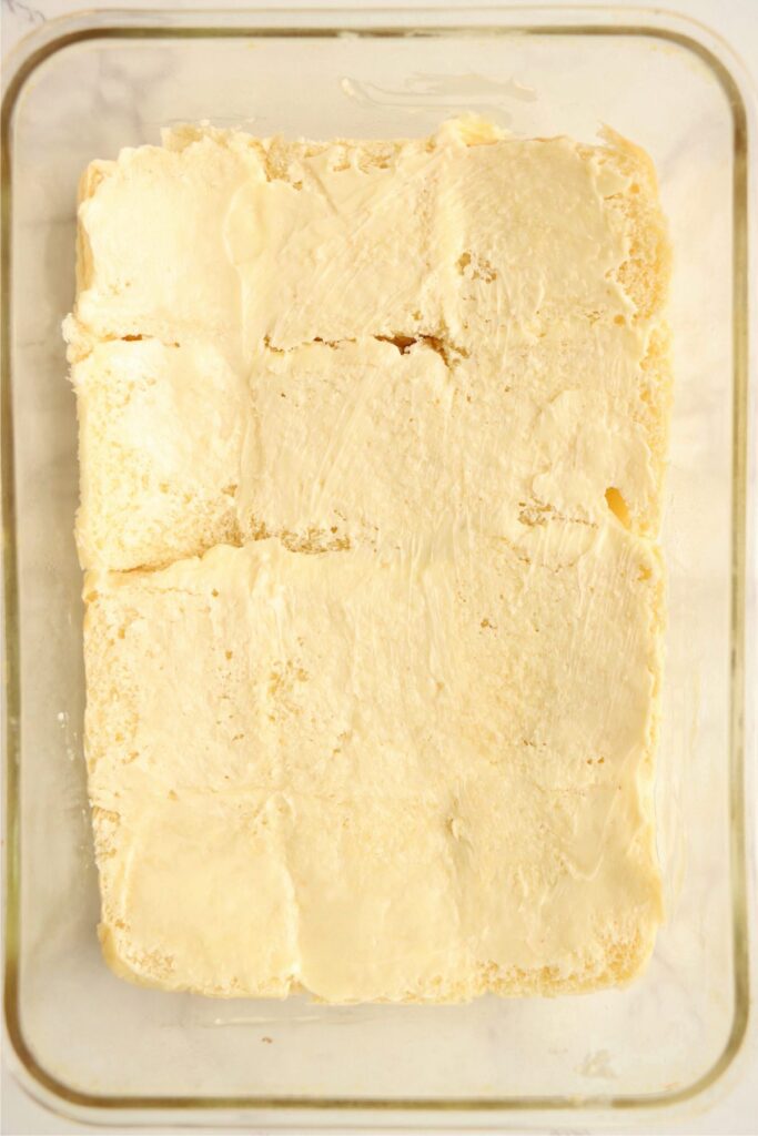 Overhead shot of Hawaiian roll bottoms topped with butter. 