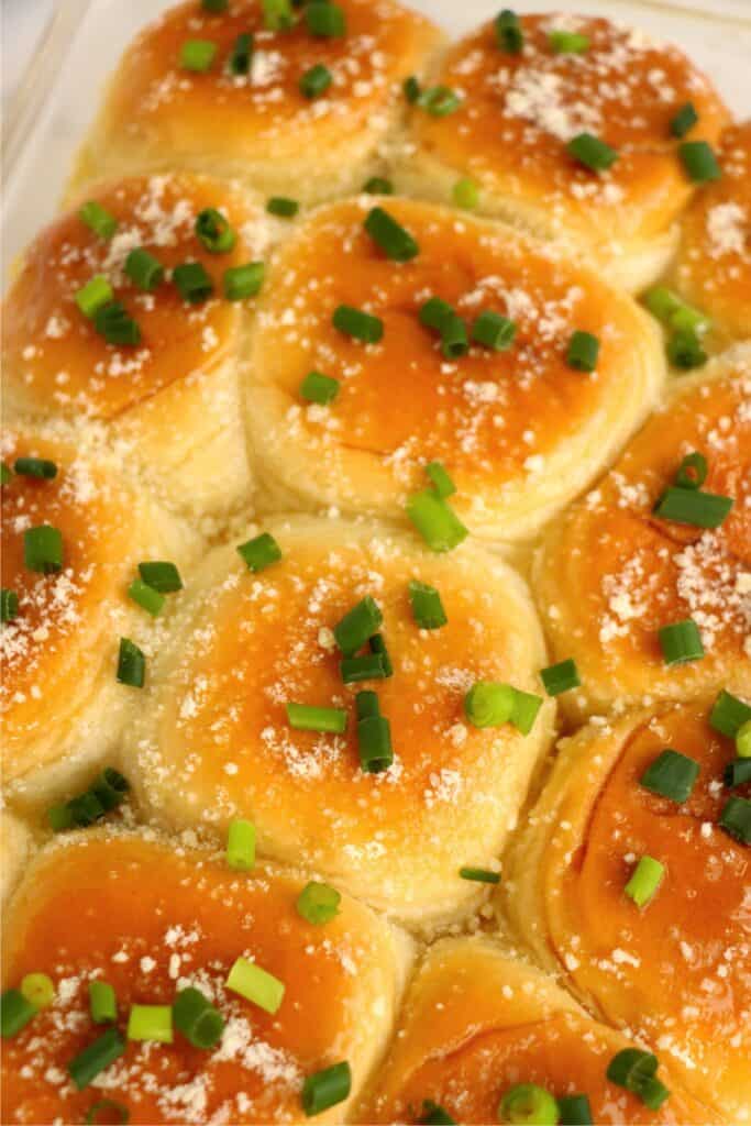 Sliders topped with melted butter, paremsan, and chives. 