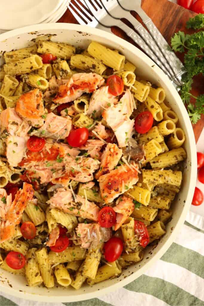 Overehad shot of skilet full of salmon and pesto pasta recipe.