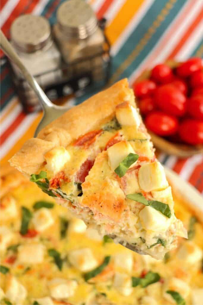 Closeup overhead shot of slice of spinach salmon quiche.