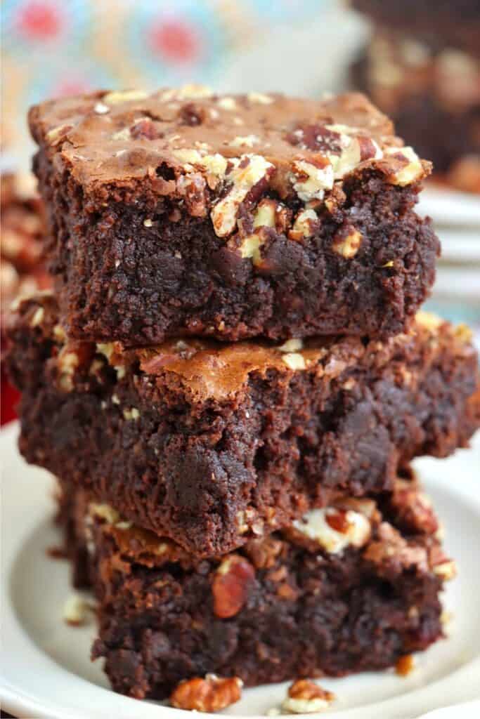 Closeup shot of three brown butter brownies stacked atop one another. 
