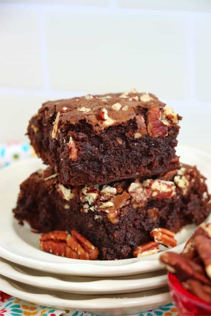 Closeup shot of two brownies on a plate.