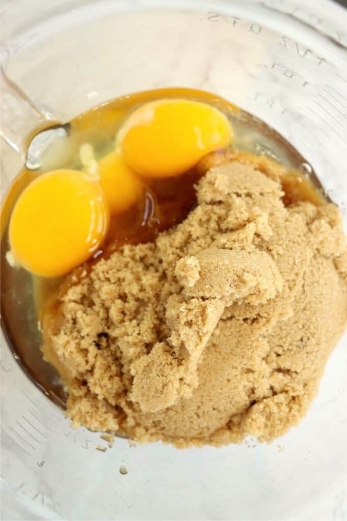 Closeup overhead shot of brown sugar and eggs in bowl. 