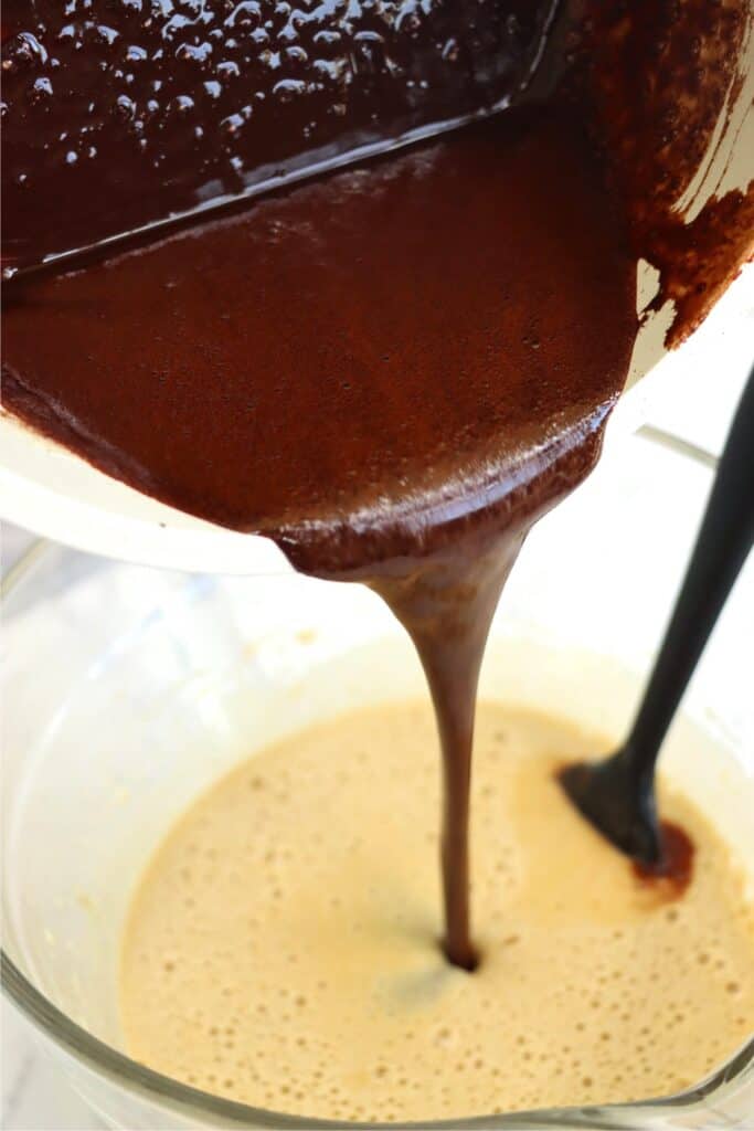 Fudge mixture being poured into egg mixture. 