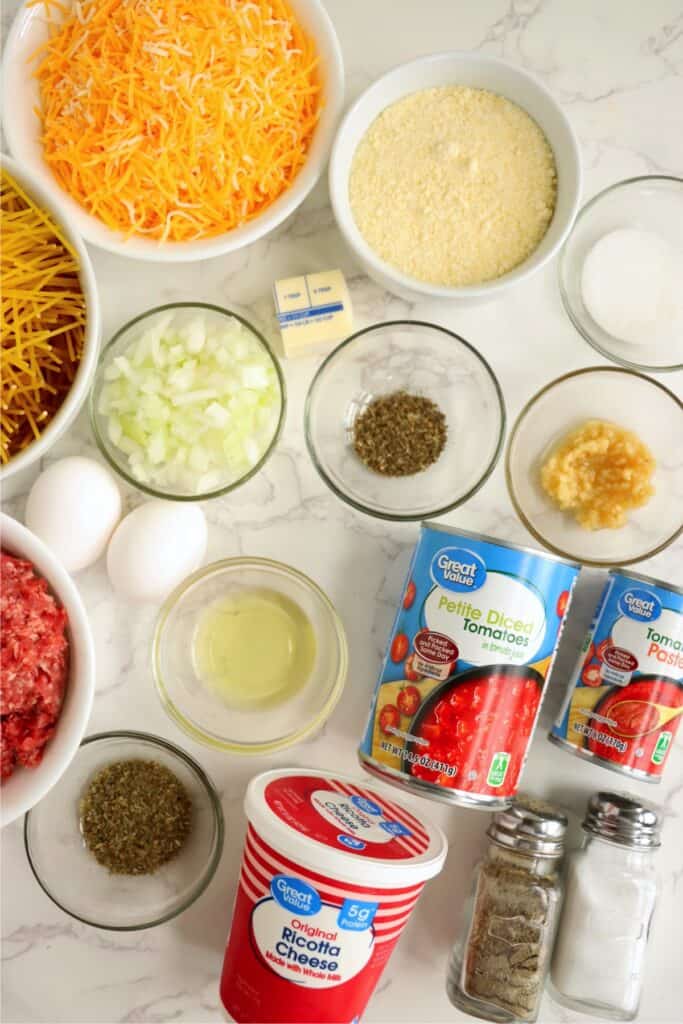 Overhead shot of individual spaghetti pie ingredients in bowls. 