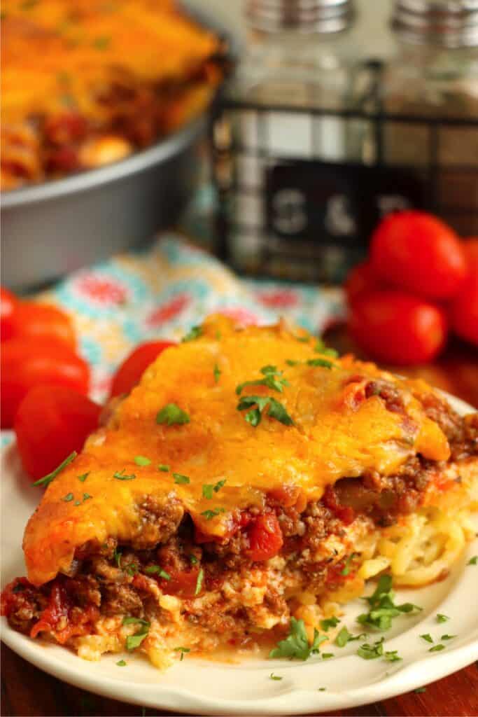 Closeup shot of slice of spaghetti pie on plate. 