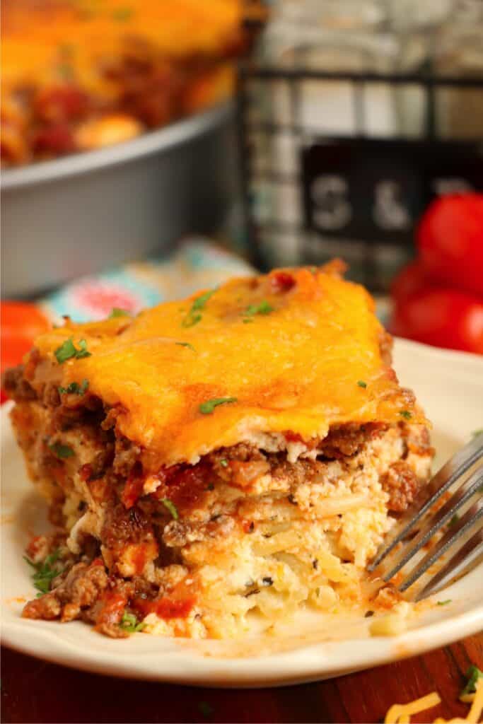 Closeup shot of slice of spaghetti pie on plate. 
