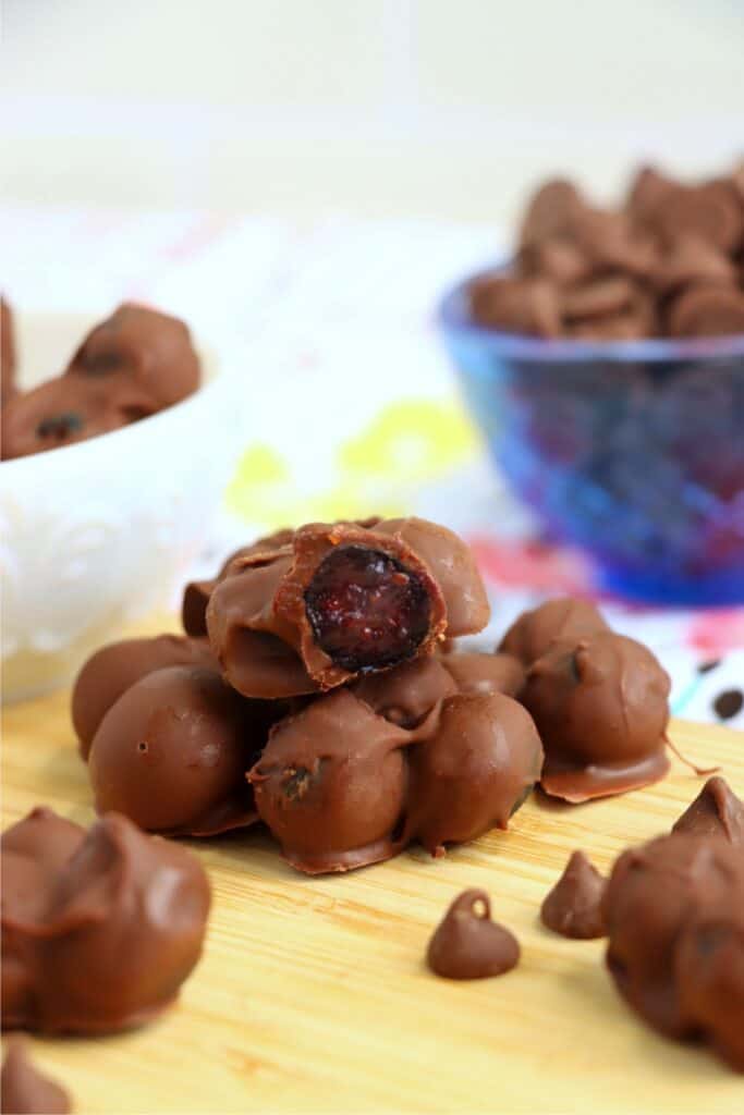 Closeup shot of chocolate covered blueberry cluster with bite taken out.