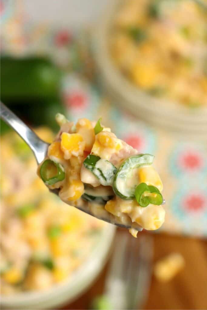 Closeup shot of spoonful of crock pot jalapeno cream corn. 