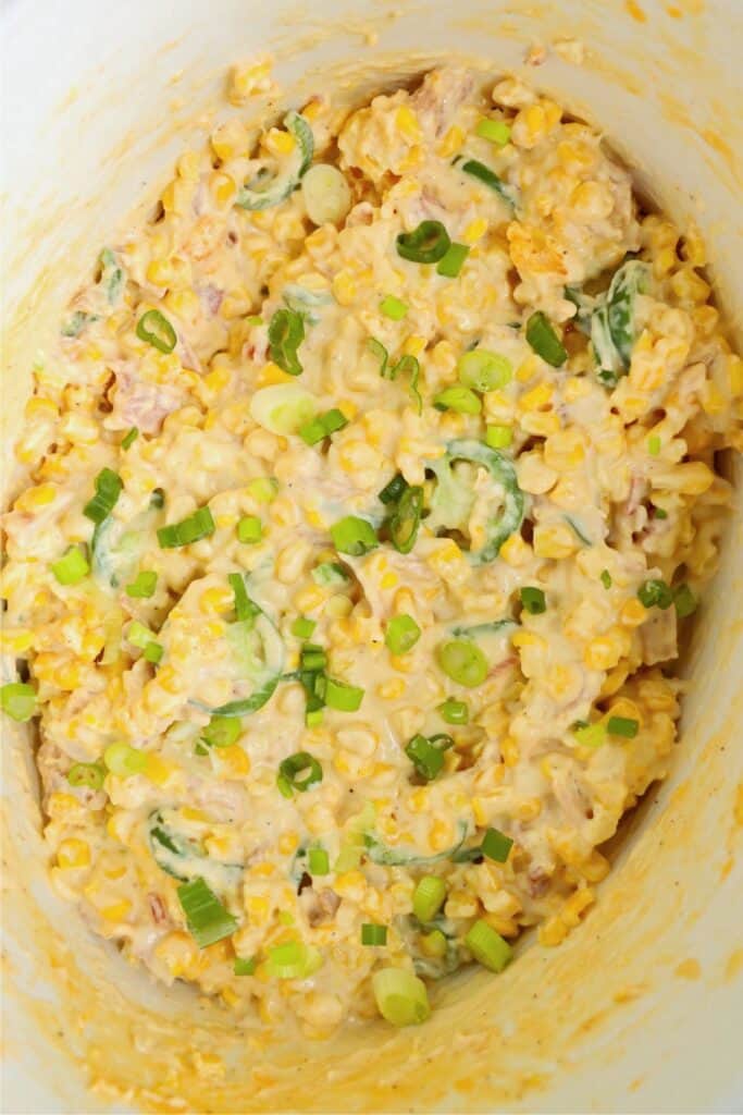 Overhead shot of crock pot jalapeno cream corn topped with green onions.