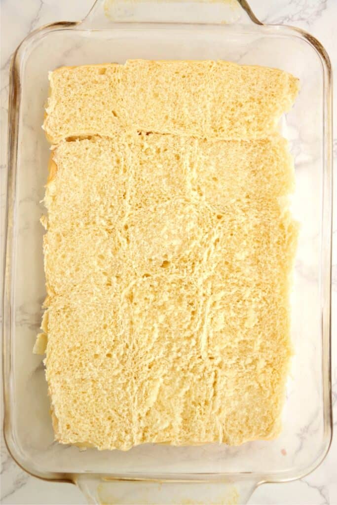 Overhead shot of Hawaiian roll bottoms in baking dish.