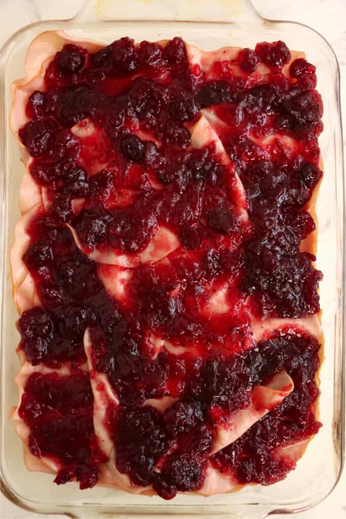 Overhead shot of turkey sliders topped with cranberry sauce.