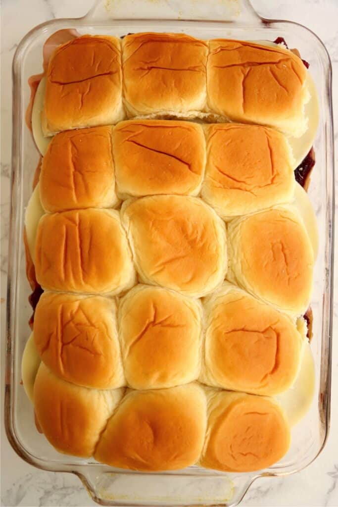 Overhead shot of unbaked turkey and cranberry sliders in baking dish. 