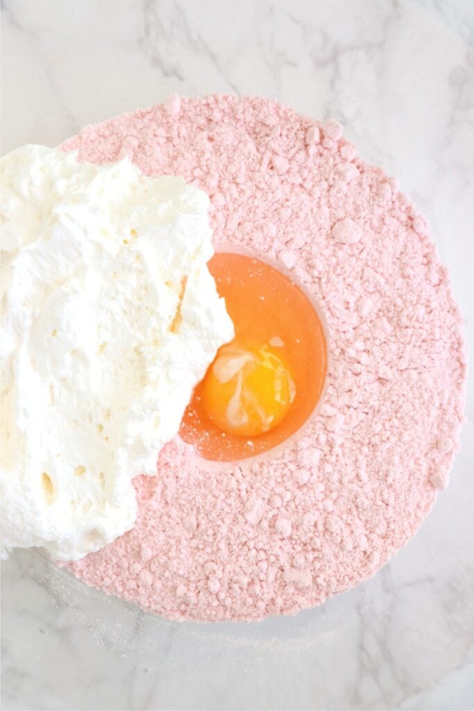 Overhead shot of bowlful of cake mix Cool Whip cookie ingredients.