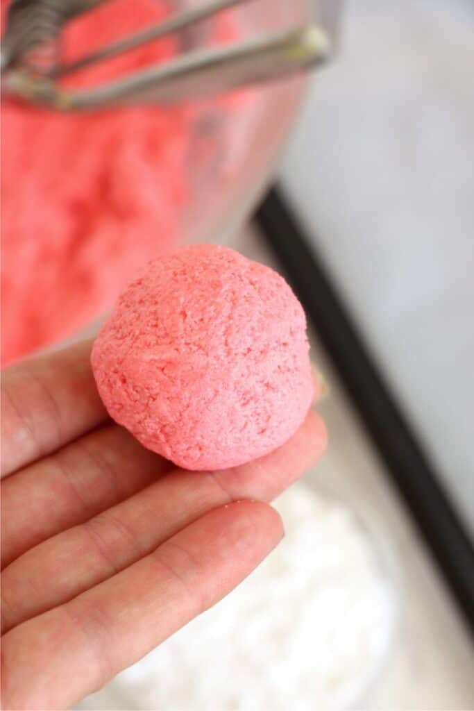Closeup shot of hand holding a ball of cake mix Cool Whip cookie dough.