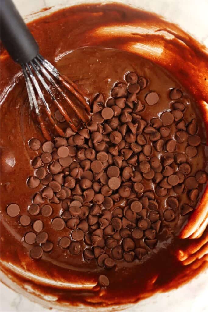 Closeup overhead shot of bowlful of brownie batter with chocolate chips. 