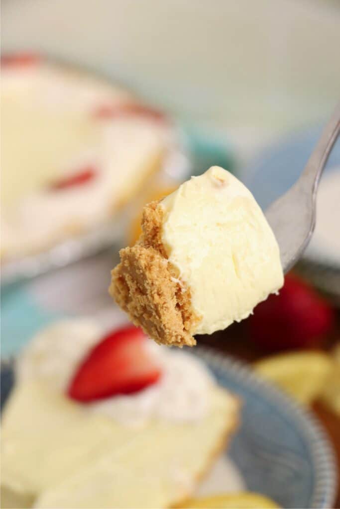 Closeup shot of forkful of lemon cream cheese pie. 