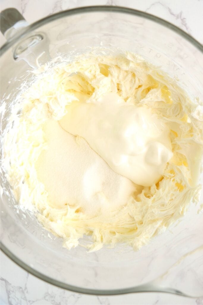 Overhead shot of bowlful of cream cheese, sugar, and sour cream.