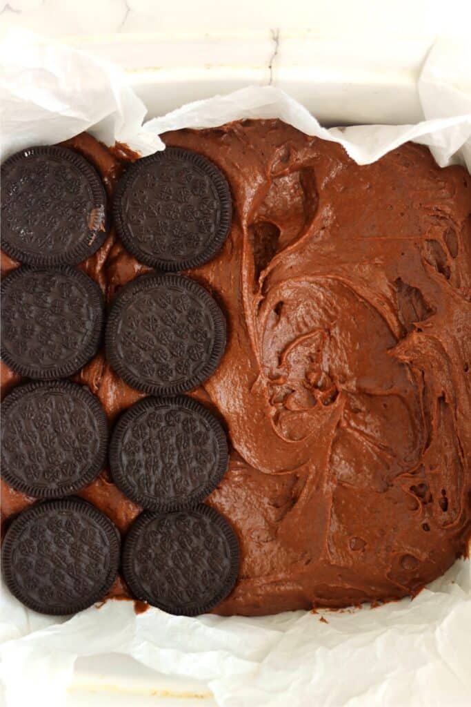 Closeup overhead shot of Oreos on top of brownie batter.