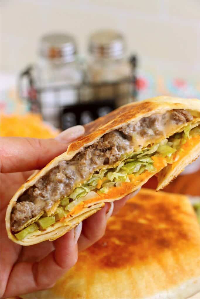 Closeup shot of hand holding half of a crunch wrap