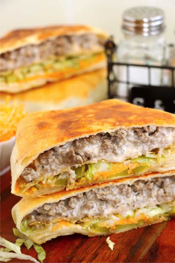 Closeup shot of two Big Mac crunchwrap halves stacked atop one another. 