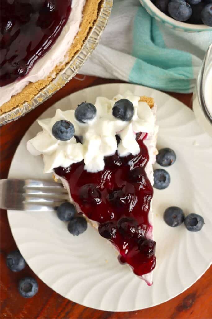 Overhead shot of slice of blueberry cream cheese pie. 