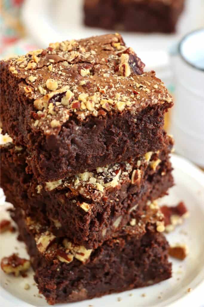 Closeup shot of three brownies stacked atop one another. 