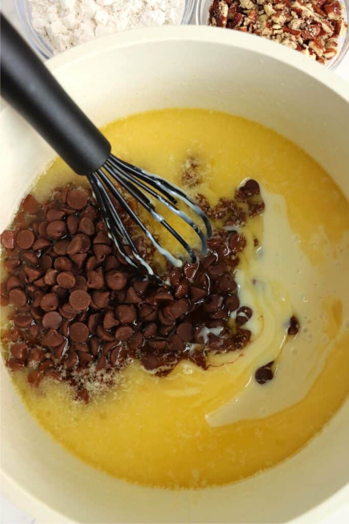 Overhead shot of melted butter and sugar with sweetened condensed milk and chocolate chips