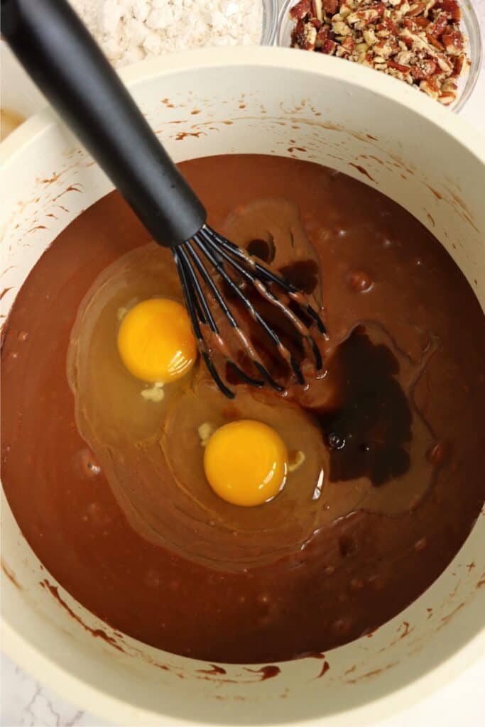 Skillet full of wet brownie batter ingredients. 