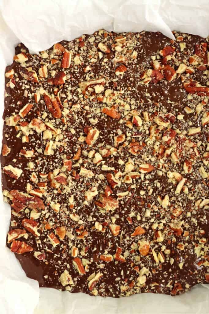 Overhead shot of brownie batter topped with nuts in pan. 