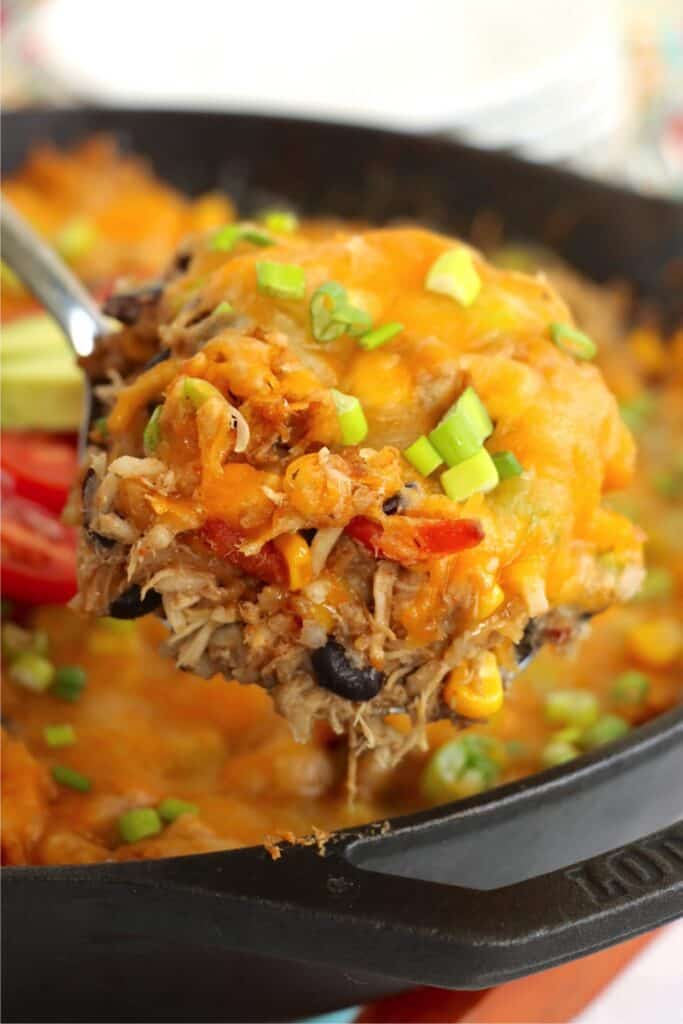 Closeup shot of spoonful of Mexican chicken and rice casserole